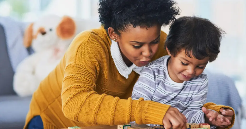 A woman and child working together with blocks