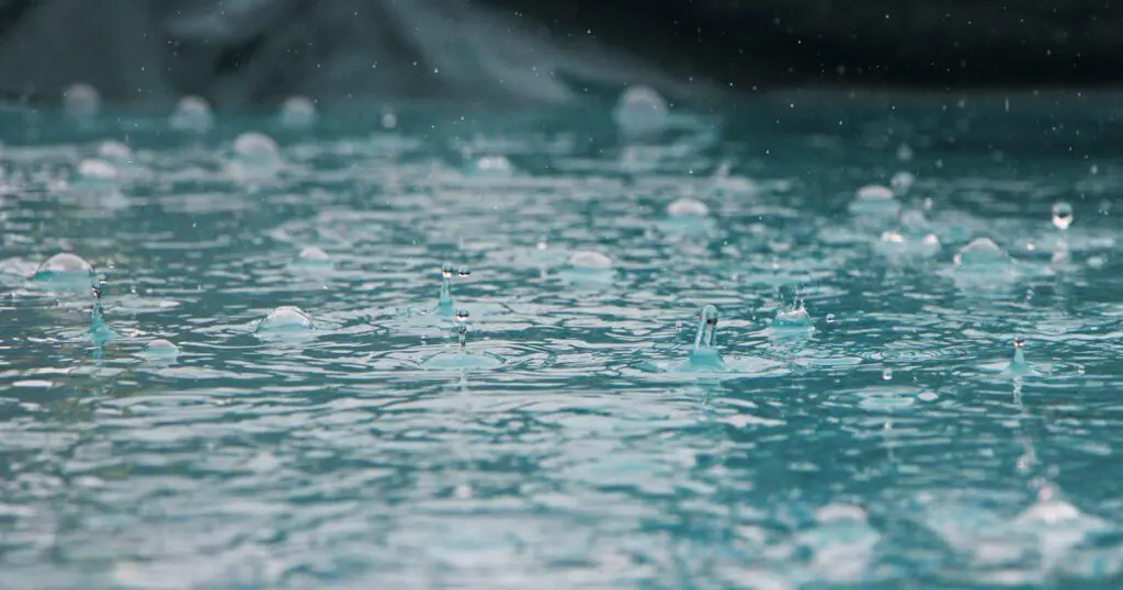 Water droplets falling into water