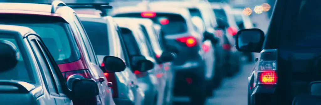 A row of motor vehicles stopped in traffic.