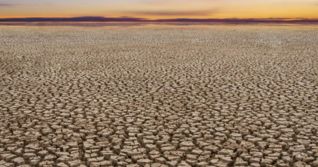 Dried ground under an orange sky