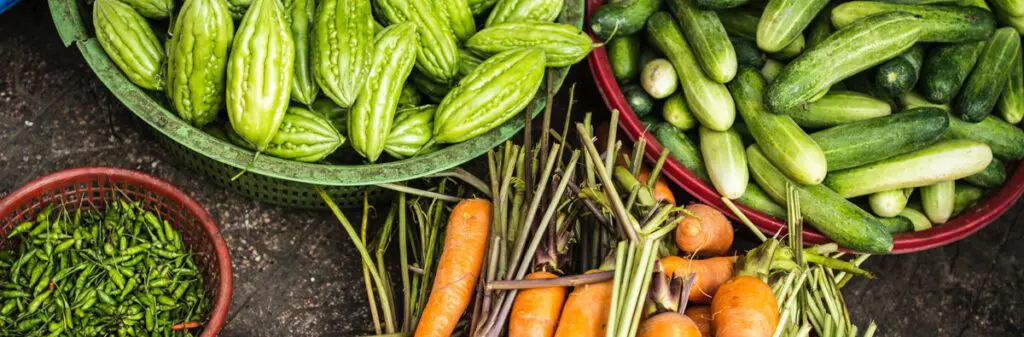 Bowls of vegetables: cucumbers, carrots.