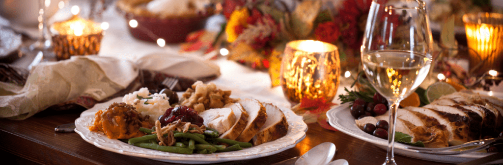 Table set for dinner party with turkey  and glasses of water 