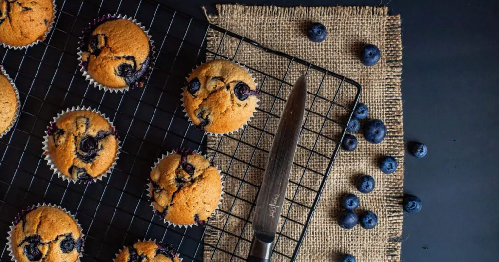 Blueberry muffins on a cooling rack.