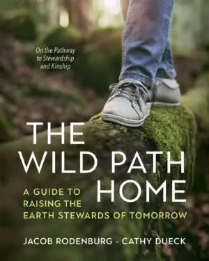 Close-up of footsteps on a mossy log with the book title "The Wild Path Home.