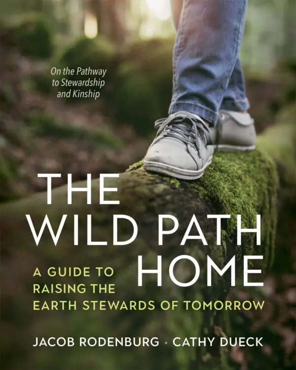 Close-up of footsteps on a mossy log with the book title "The Wild Path Home.