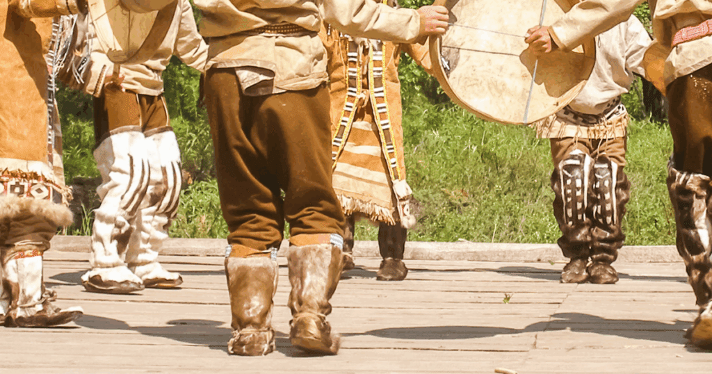 Indigenous dance outdoors, reflecting on the Indian Act’s ethical perspective, indian.