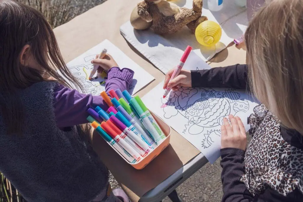 Two children color at a table, inspired by When Kids Rule the School by Jim Rietmulder.