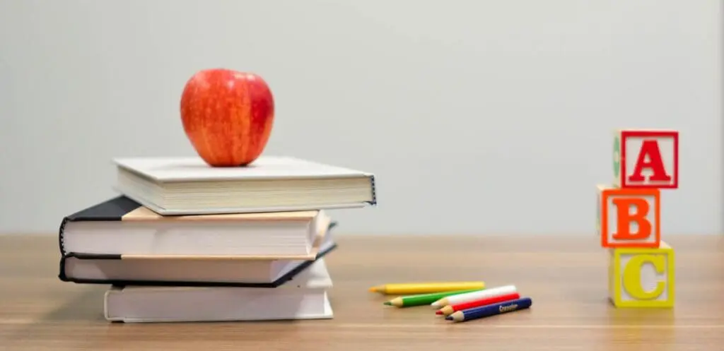 A red apple on stacked books, pencils, and ABC blocks hints at When Kids Rule the School.