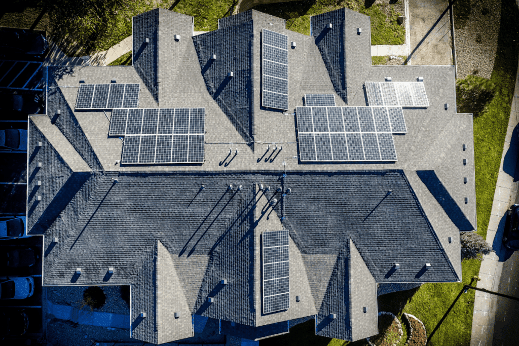 Aerial view of a gray roof with solar panels, saving about 2.5 tonnes via carbon math.