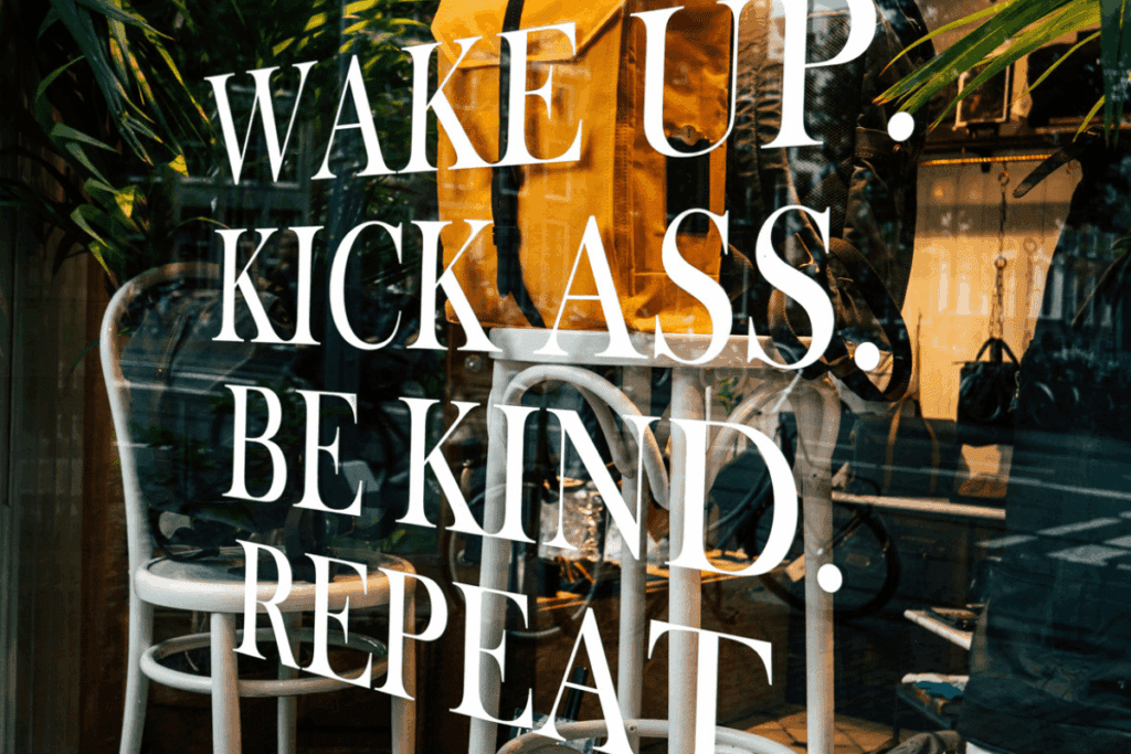 White text on a shop window reads: Wake up. Kick ass. Tackle climate change. Repeat.