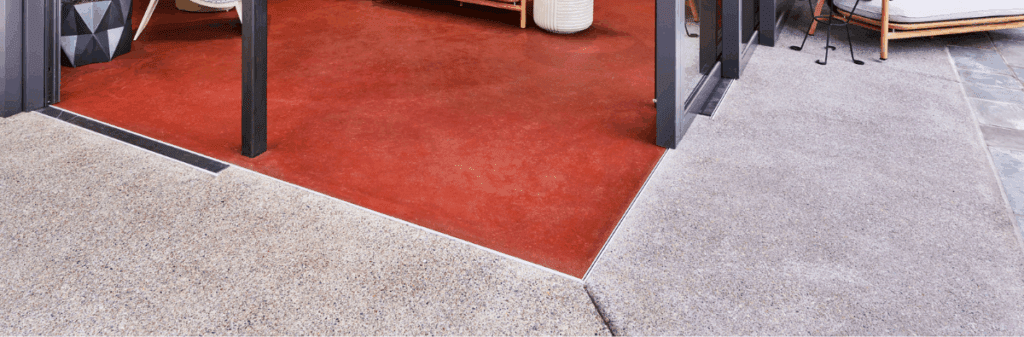 Red indoor flooring meets light outdoor concrete—explore sustainable subfloors at the threshold.