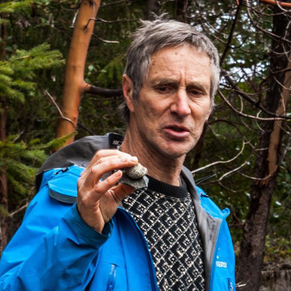 author Steven Earle, examining some rocks in his hand
