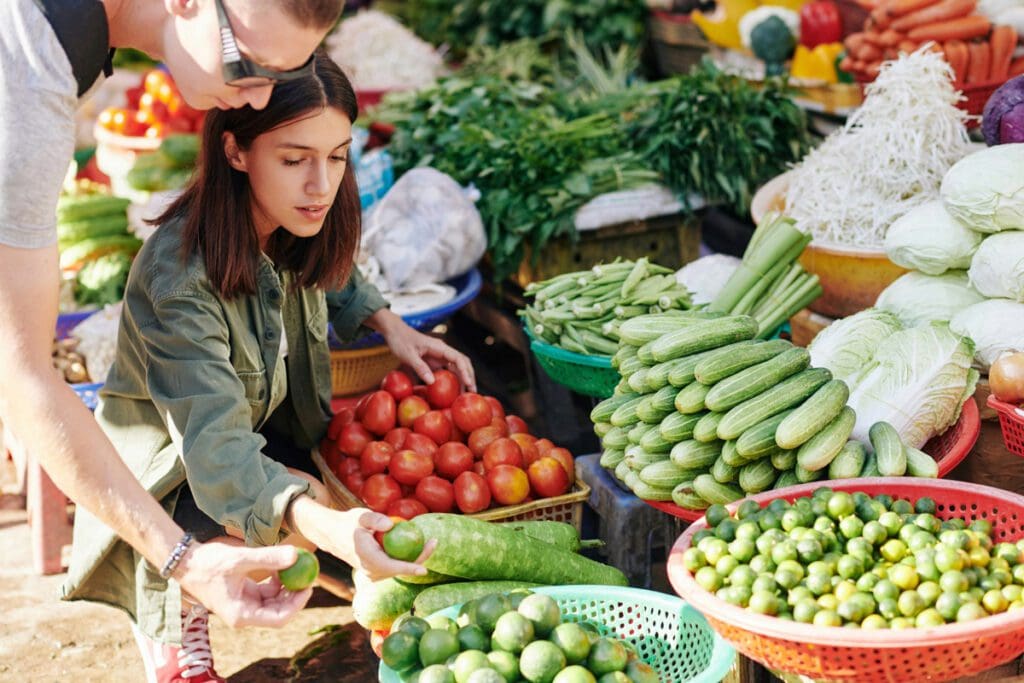 A variety of vegetables available for sale at a farmer's market stall