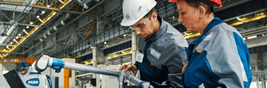 Two factory workers, a man and a woman on the floor