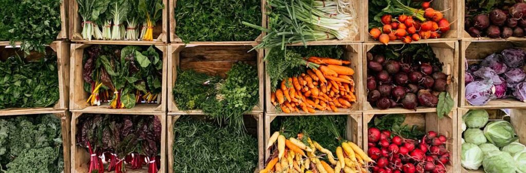 Overhead shot of vegetables in wooden boxes.