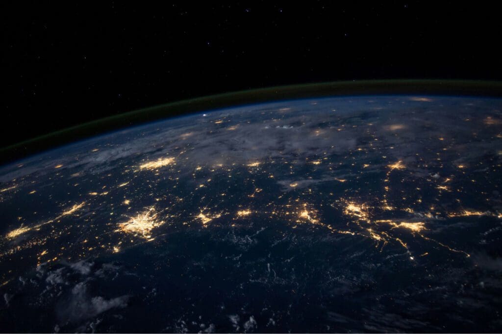 Earth from space at night with cities lit up