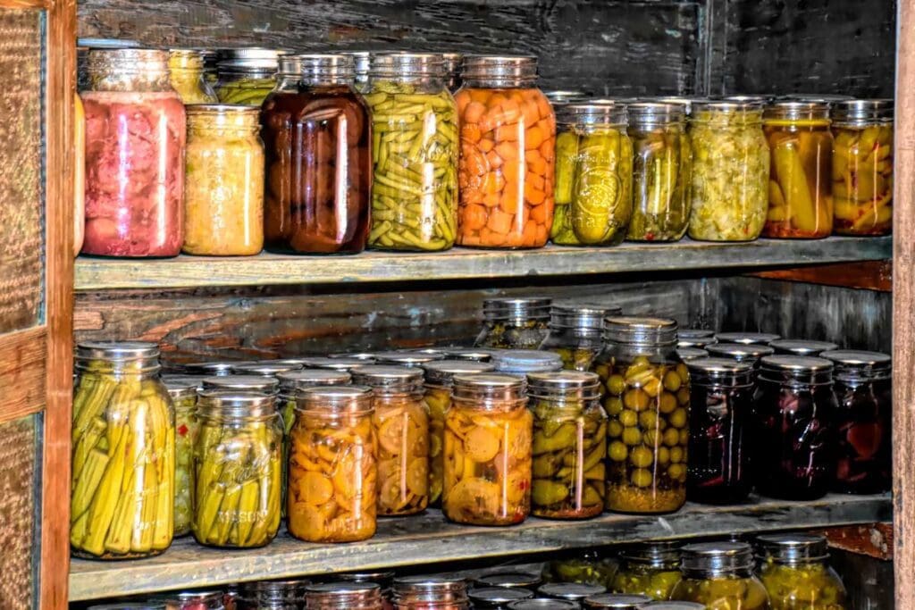 A cupboard filled with jars of preserves.