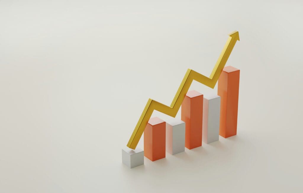An image of a bar graph with trending upwards arrow in 3D.