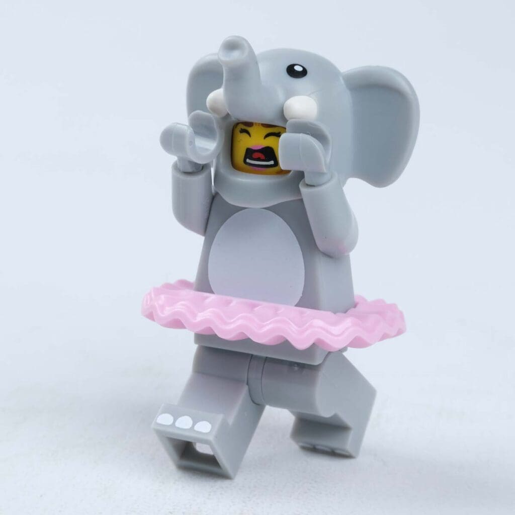 A plastic toy elephant wears a totu.
