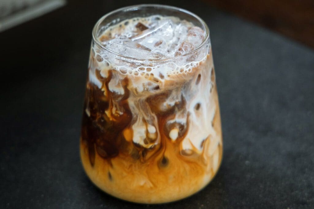 A clear glass of Irish Cream with ice.
