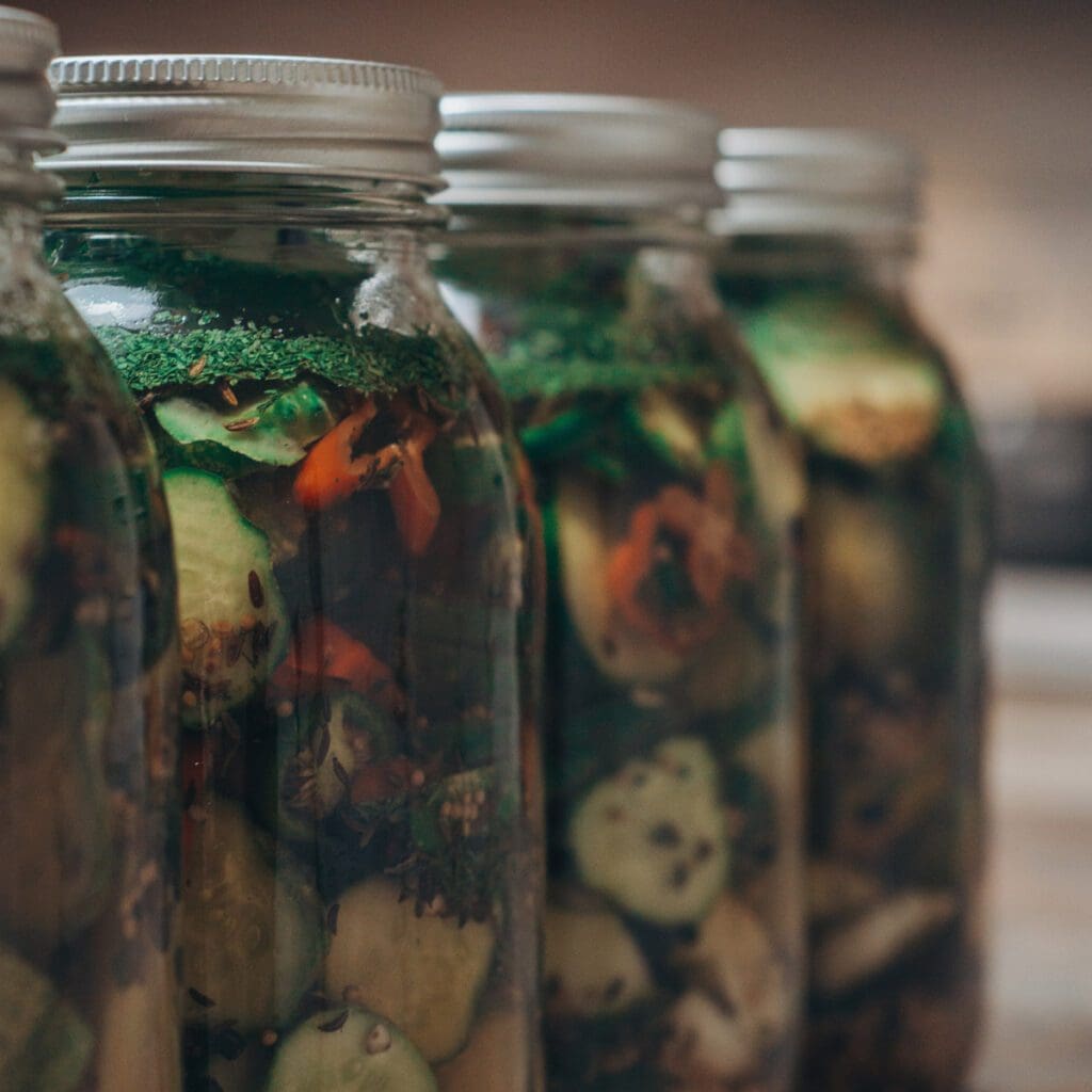 Vegetable preserves in four mason jars.
