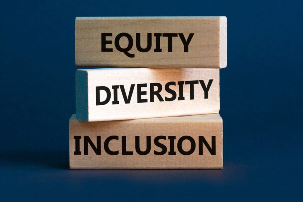 Stacked wooden blocks with the words: Equity, Diversity, Inclusion on a dark blue background highlight the vital aspects of racial discourse.