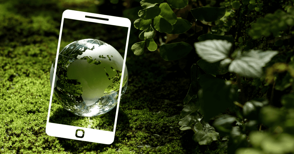 A smartphone outline frames a globe on a forest floor, highlighting its carbon footprint.