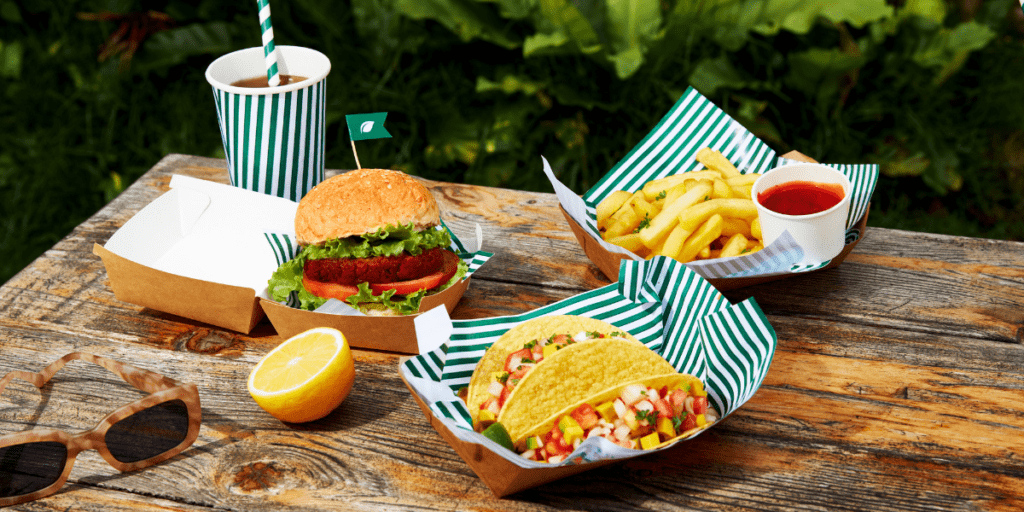 Burger, tacos, and fries await at a rustic table, perfect for a truck stop break.