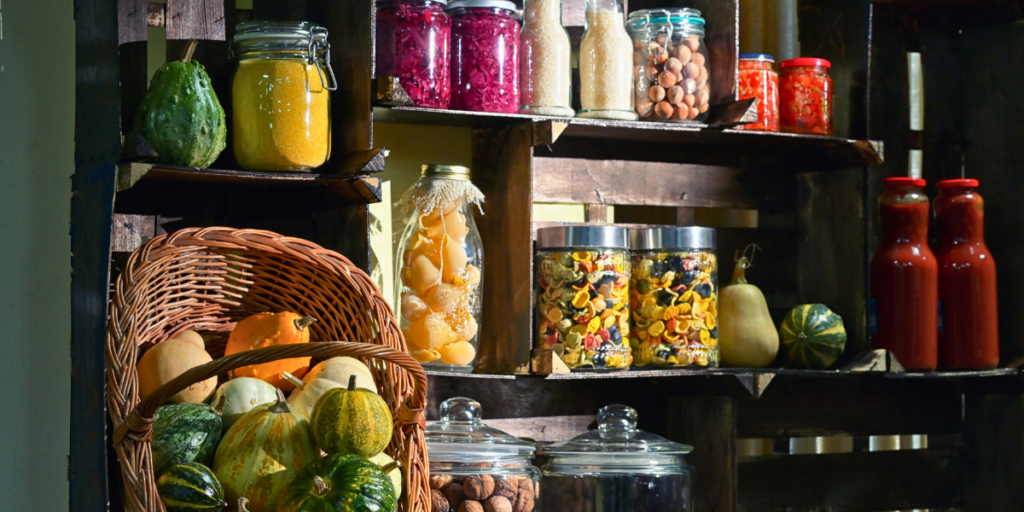 Rustic pantry shelf with jars, spices, squash, baskets; perfect for a sustainable food plan.