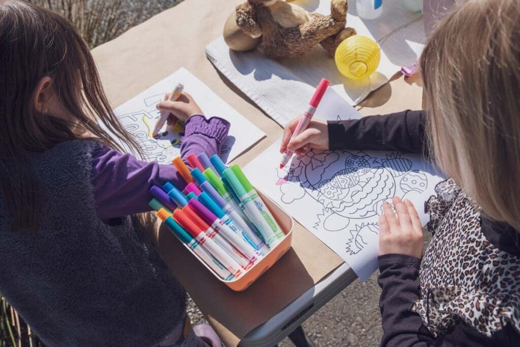 Two children color at a table, inspired by When Kids Rule the School by Jim Rietmulder.
